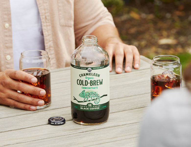 An image of a table with a bottle of black coffee placed on it, inviting you to savor its rich flavor.